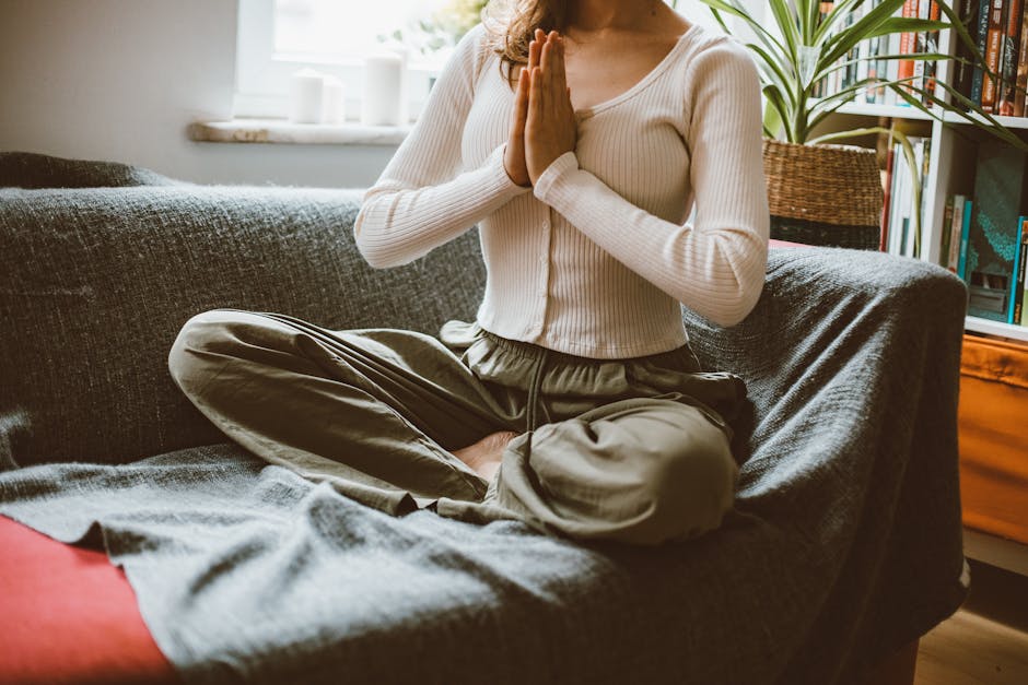 A woman practicing yoga in a cozy indoor setting