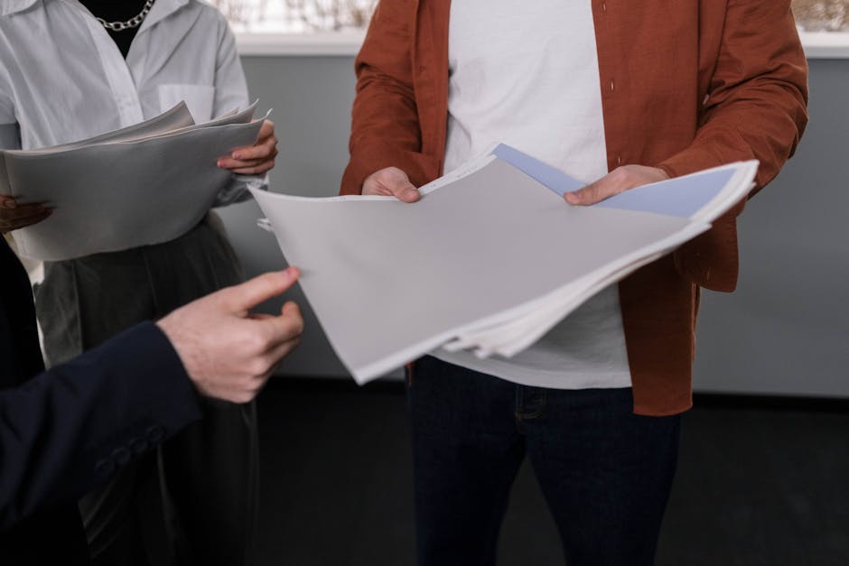 Business professionals discussing interior design samples during a project meeting